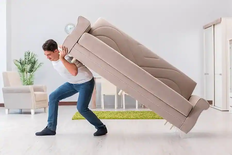 Man moving a sofa